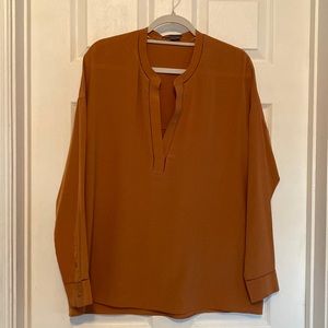 Vince Copper colored 100% silk blouse with pointelle detail.